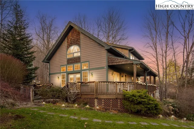 a view of a house with yard and sitting area