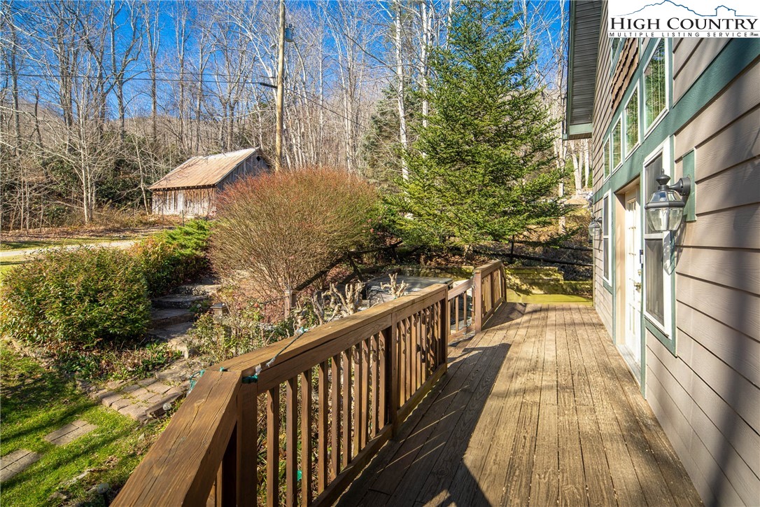 144 Grandfather Farms Road Banner Elk, NC 28604 - Photo 13 of 41 a view of a balcony with wooden floor and fence