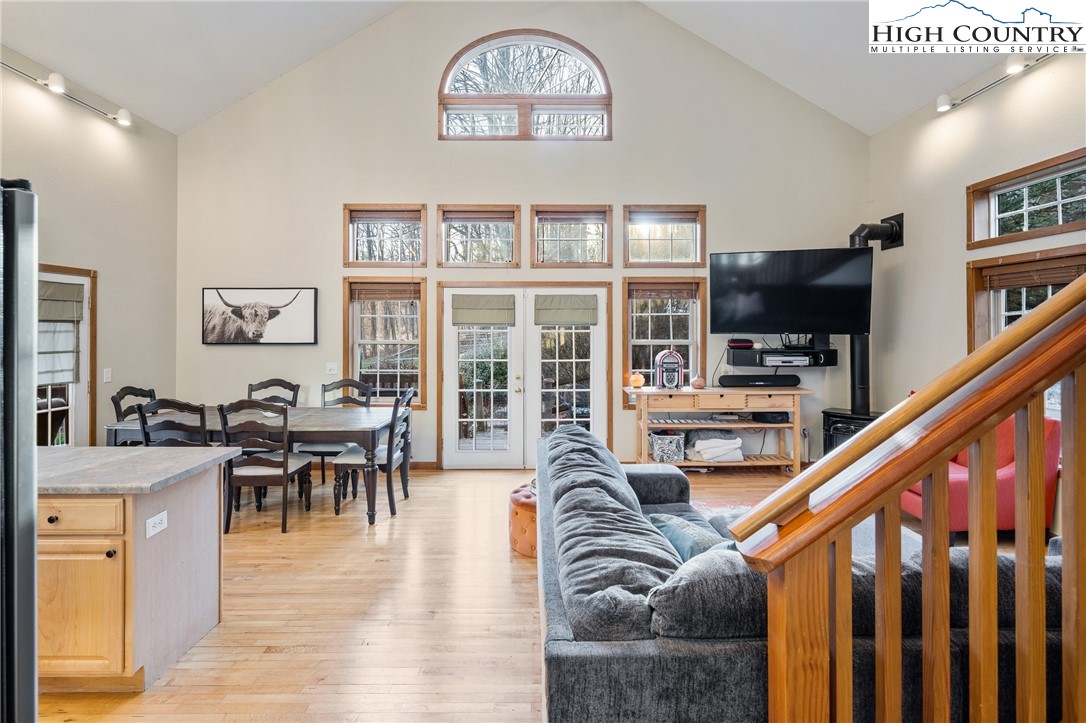 144 Grandfather Farms Road Banner Elk, NC 28604 - Photo 14 of 41 a living room with furniture a dining table and a bookshelf with wooden floor