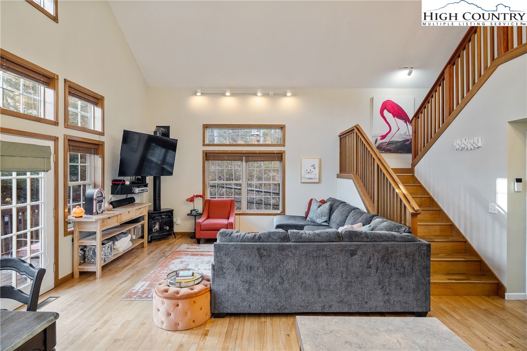 144 Grandfather Farms Road Banner Elk, NC 28604 - Photo 15 of 41 a living room with furniture flat screen tv and a large window
