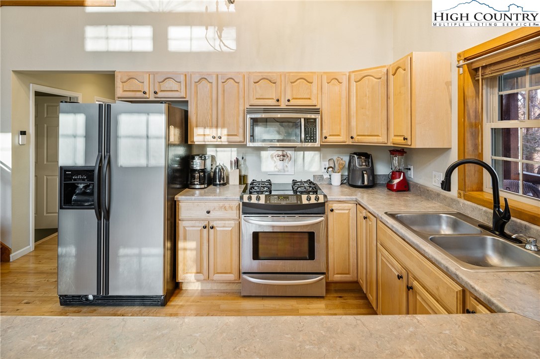 144 Grandfather Farms Road Banner Elk, NC 28604 - Photo 16 of 41 a kitchen with stainless steel appliances granite countertop a sink stove and refrigerator