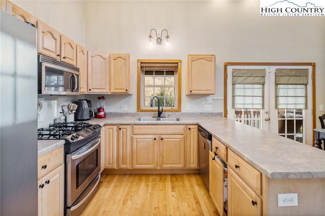 144 Grandfather Farms Road Banner Elk, NC 28604 - Photo 17 of 41 a kitchen with stainless steel appliances granite countertop a stove a sink and a microwave