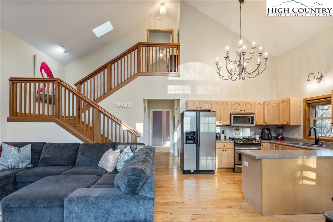 144 Grandfather Farms Road Banner Elk, NC 28604 - Photo 20 of 41 a living room with stainless steel appliances kitchen island granite countertop a couch a dining table and chairs
