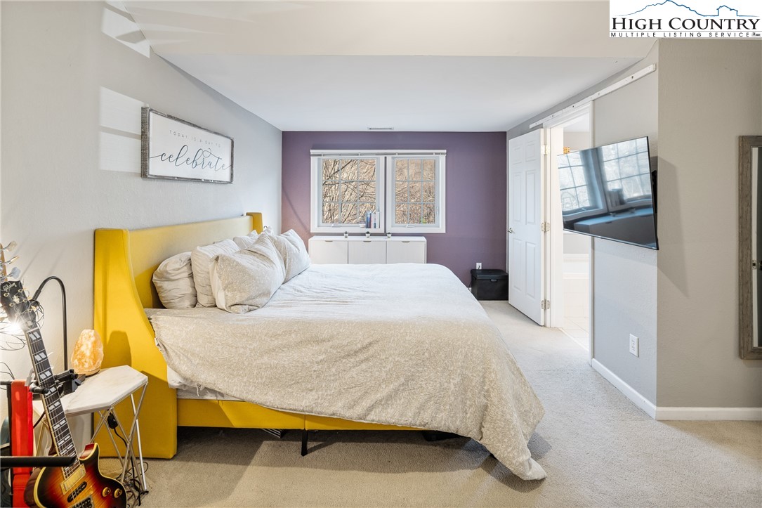 144 Grandfather Farms Road Banner Elk, NC 28604 - Photo 23 of 41 a bedroom with a bed and wooden floor