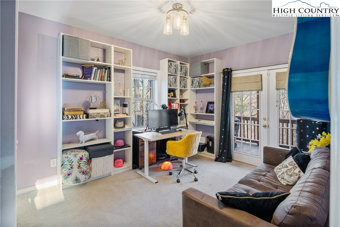 144 Grandfather Farms Road Banner Elk, NC 28604 - Photo 27 of 41 a living room with furniture a chandelier and a large window