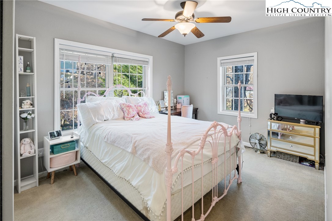 144 Grandfather Farms Road Banner Elk, NC 28604 - Photo 32 of 41 a bedroom with a bed and a flat screen tv