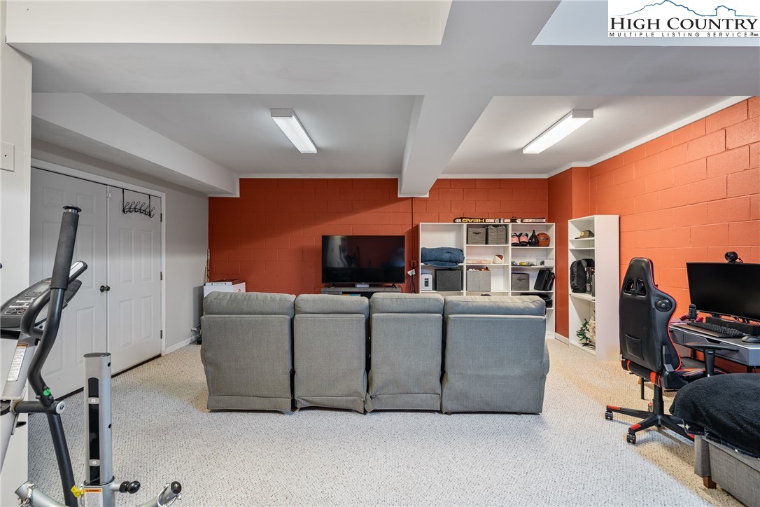 144 Grandfather Farms Road Banner Elk, NC 28604 - Photo 35 of 41 a living room with furniture and a flat screen tv