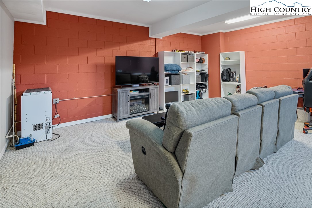 144 Grandfather Farms Road Banner Elk, NC 28604 - Photo 36 of 41 a living room with furniture and a flat screen tv