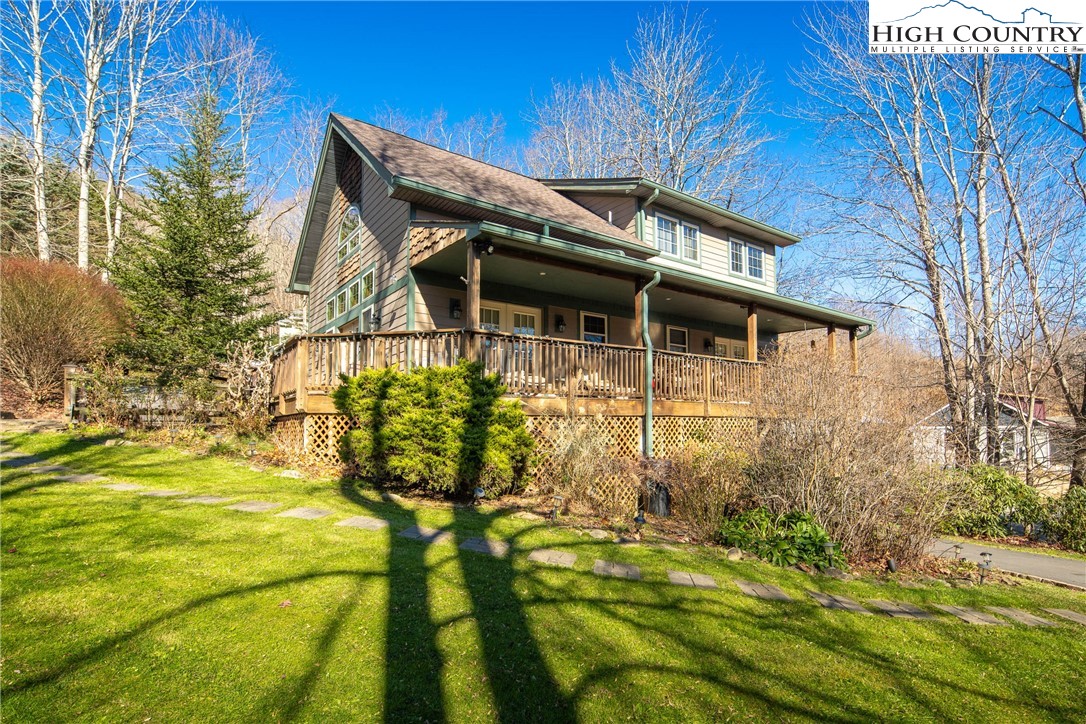 144 Grandfather Farms Road Banner Elk, NC 28604 - Photo 7 of 41 a backyard of a house with large trees and wooden fence