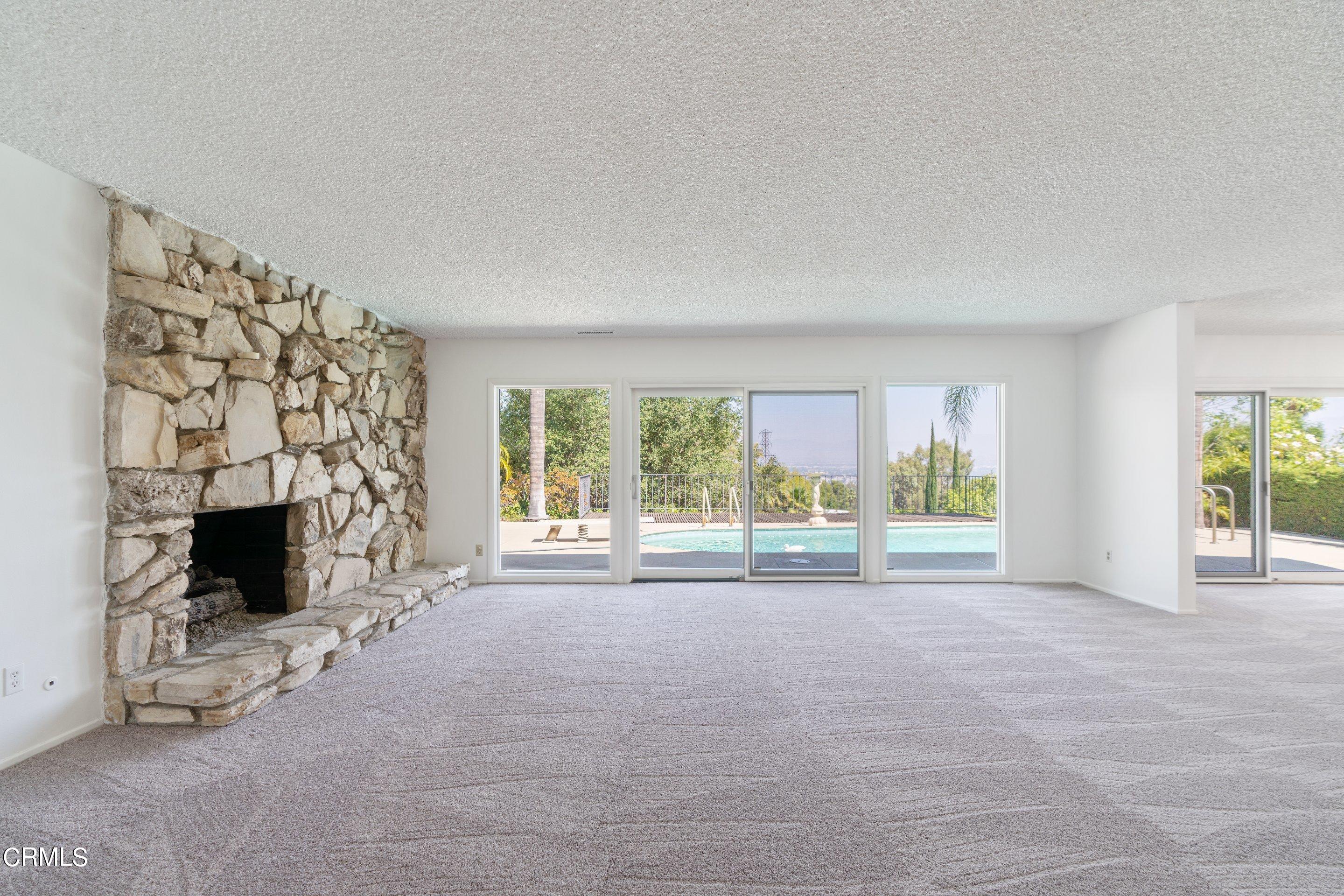 3347 Wrightwood Drive Studio City, CA 91604 - Photo 11 of 44 a view of an empty room with a fireplace and a large window
