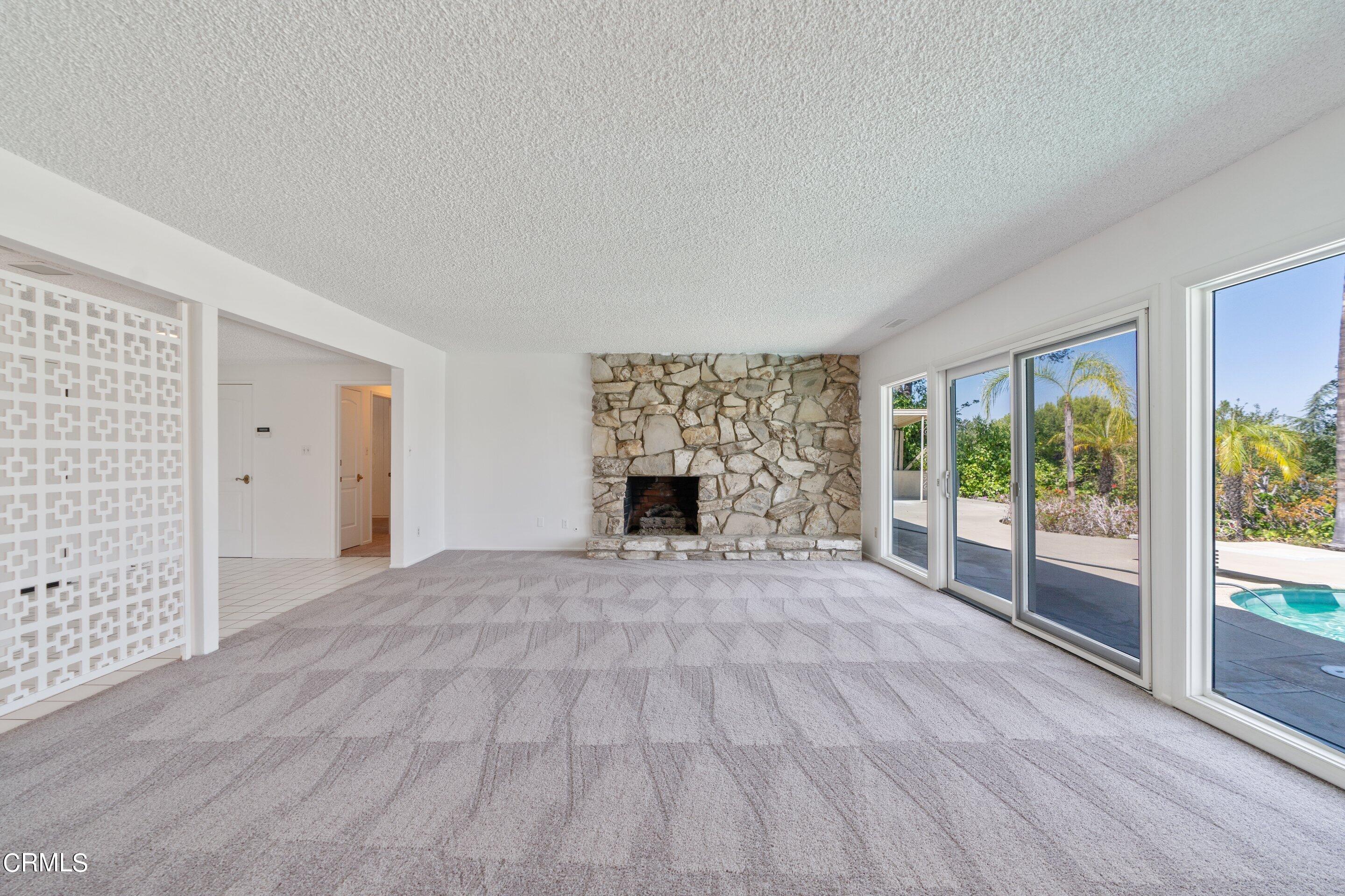 3347 Wrightwood Drive Studio City, CA 91604 - Photo 12 of 44 a view of an empty room with a fireplace and a window