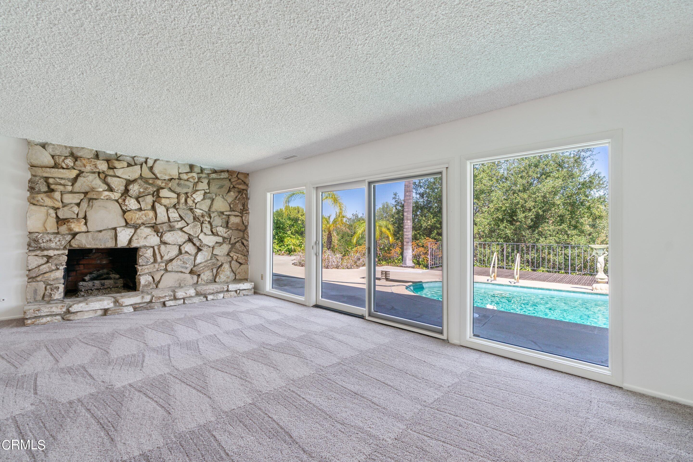 3347 Wrightwood Drive Studio City, CA 91604 - Photo 13 of 44 a view of an empty room with a fireplace and a window