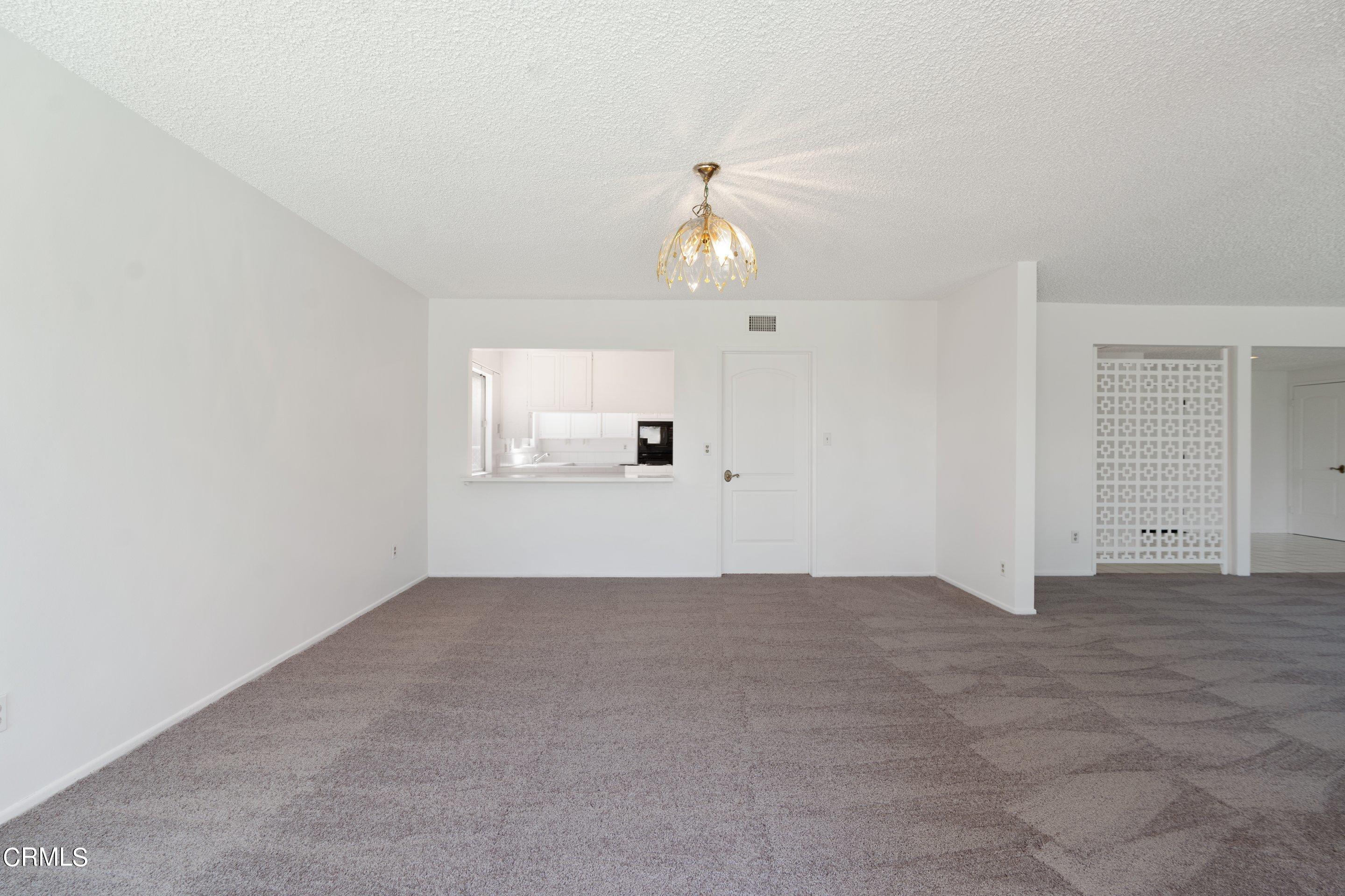 3347 Wrightwood Drive Studio City, CA 91604 - Photo 16 of 44 an empty room with chandelier and windows