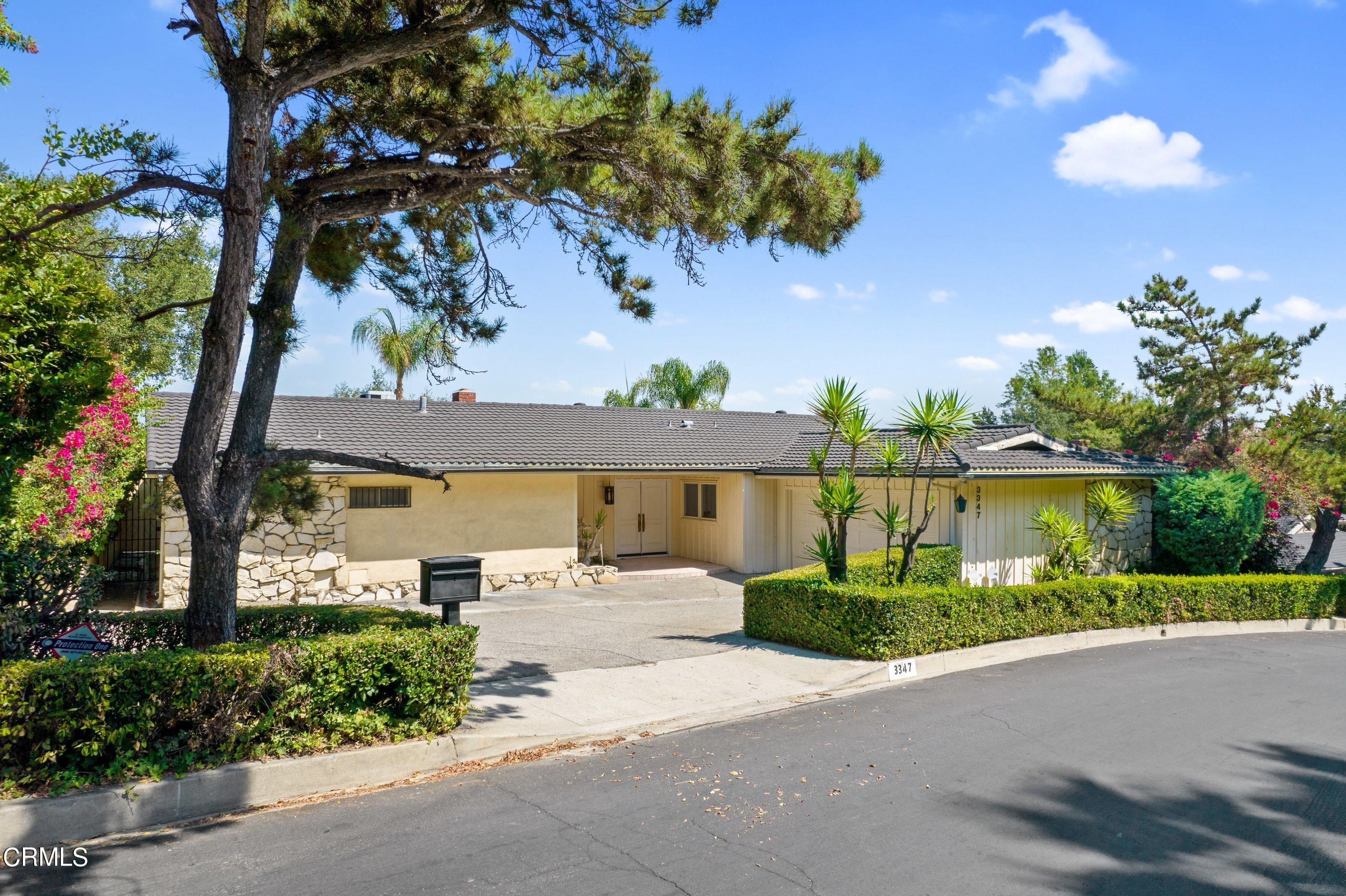 3347 Wrightwood Drive Studio City, CA 91604 - Photo 3 of 44 a front view of a house with a yard and potted plants