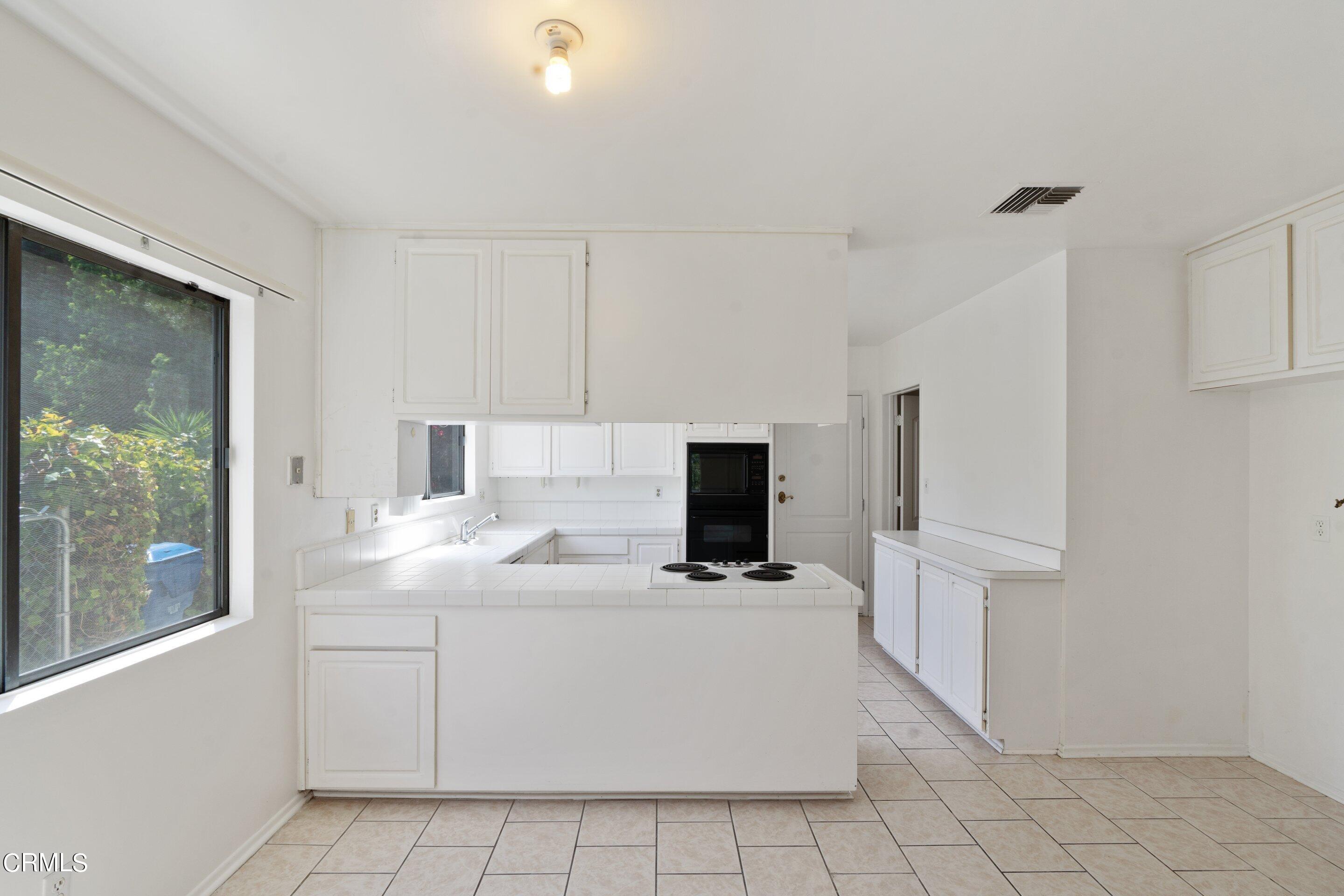 3347 Wrightwood Drive Studio City, CA 91604 - Photo 24 of 44 a kitchen with cabinets and white appliances