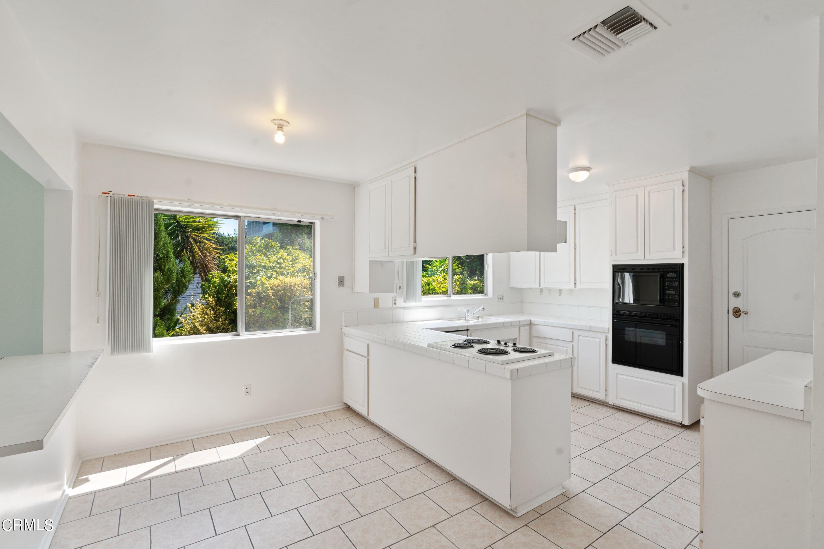 3347 Wrightwood Drive Studio City, CA 91604 - Photo 26 of 44 a kitchen with white cabinets and appliances