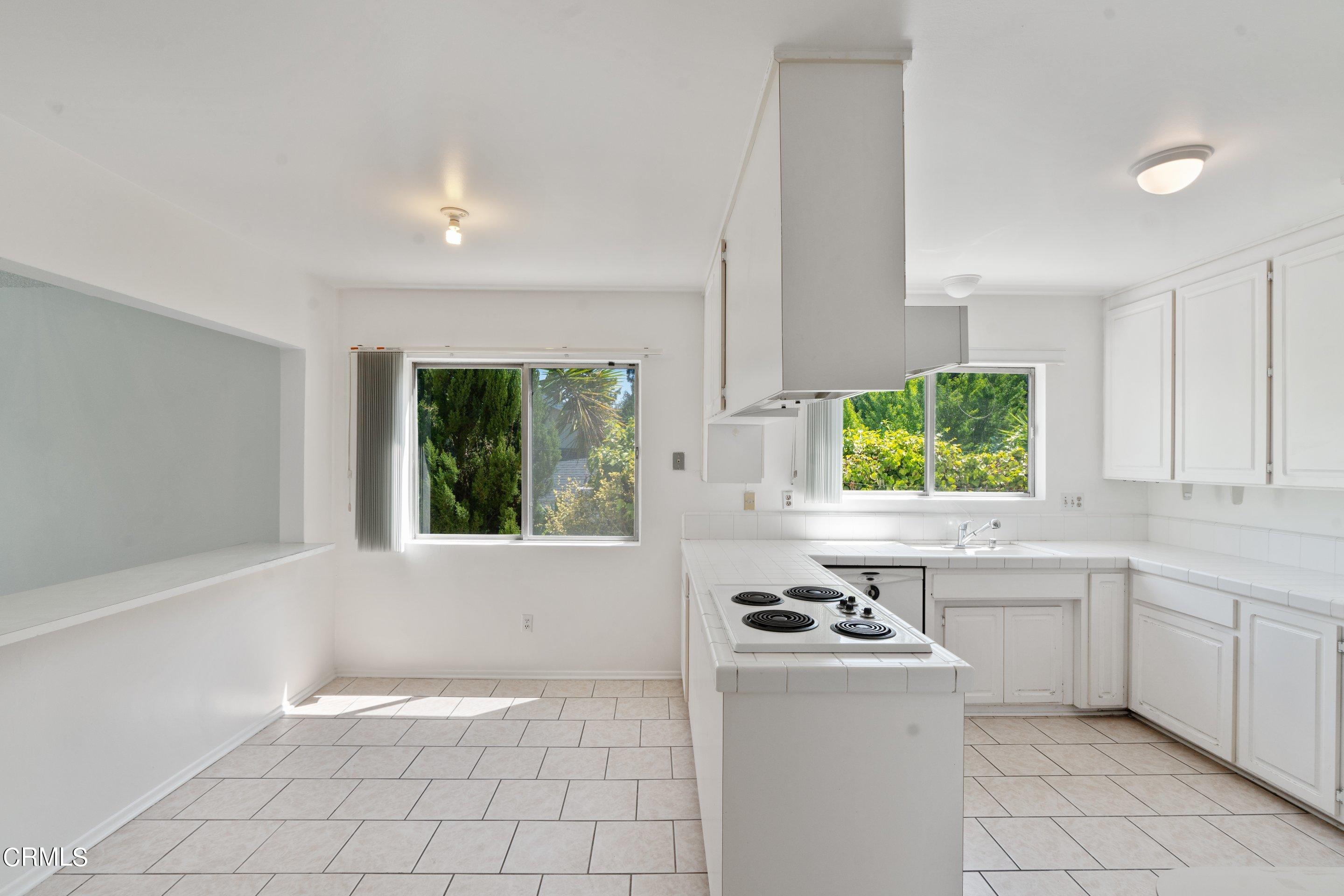 3347 Wrightwood Drive Studio City, CA 91604 - Photo 27 of 44 a kitchen with a sink appliances and cabinets