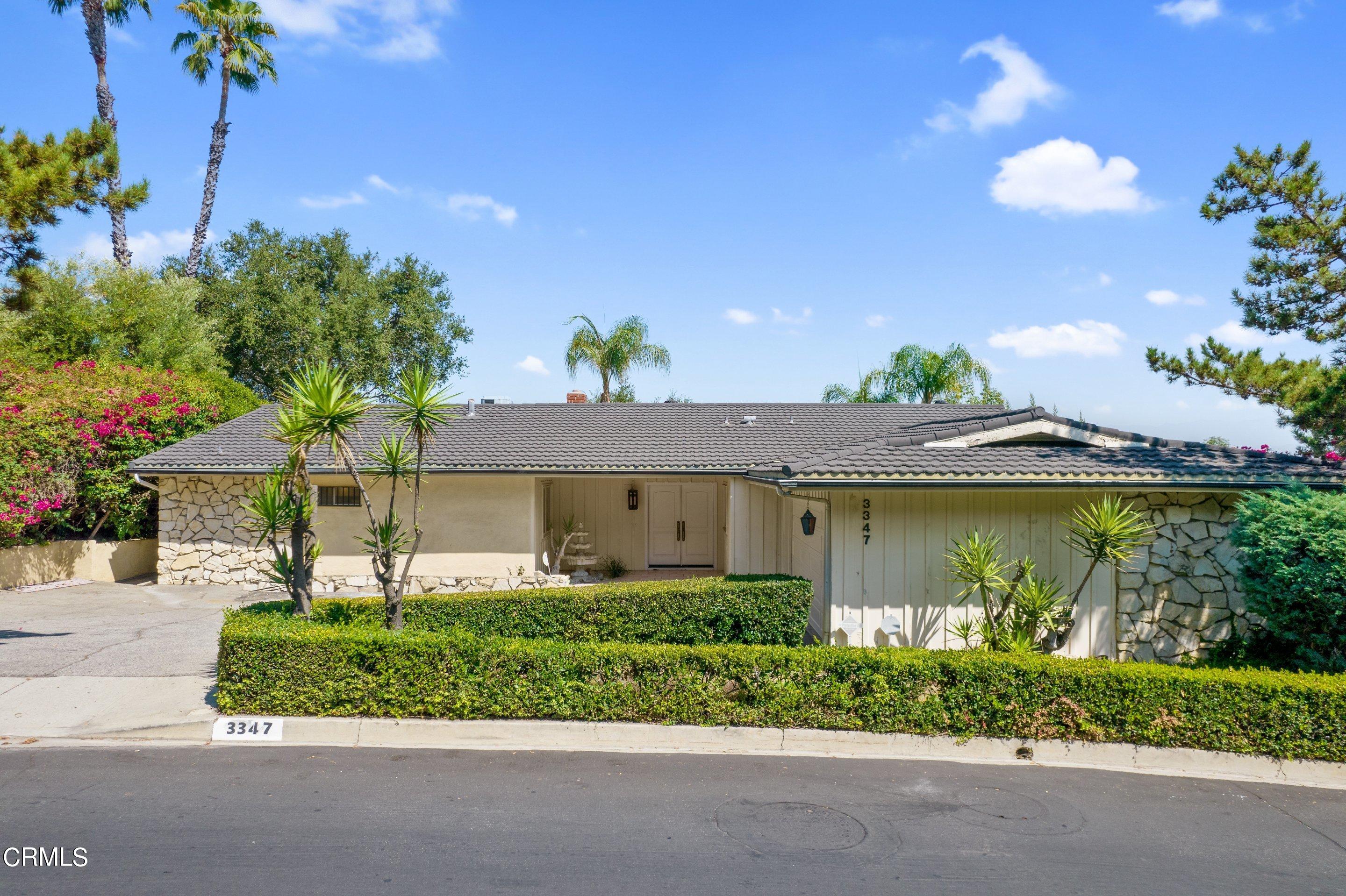3347 Wrightwood Drive Studio City, CA 91604 - Photo 4 of 44 a front view of a house with a yard