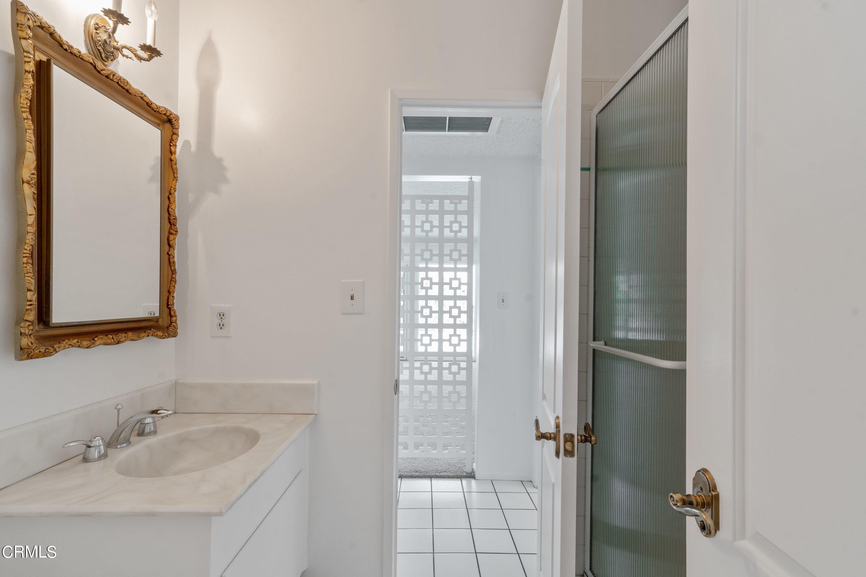 3347 Wrightwood Drive Studio City, CA 91604 - Photo 31 of 44 a bathroom with a sink and mirror with toilet