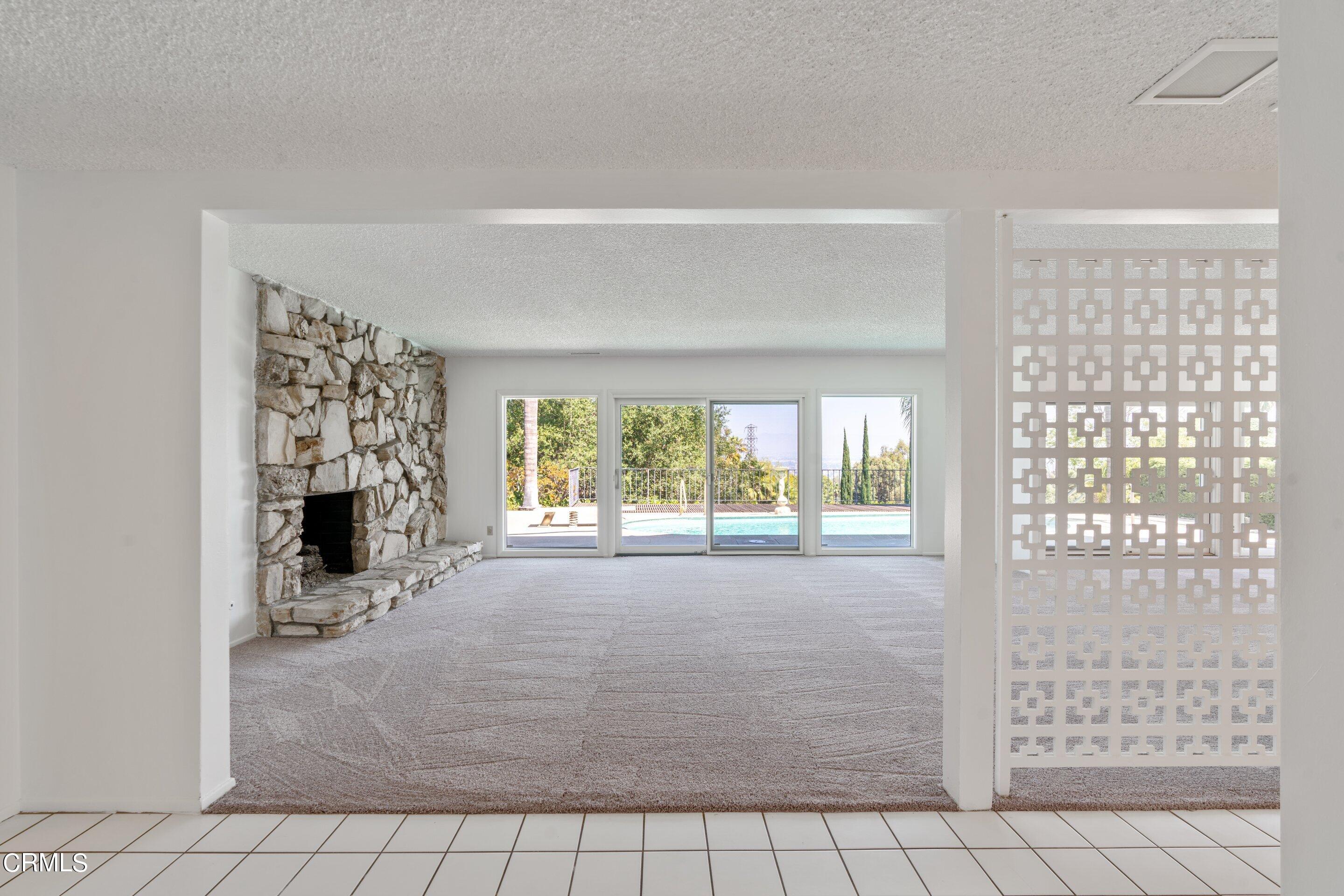 3347 Wrightwood Drive Studio City, CA 91604 - Photo 8 of 44 a view of an empty room with a fireplace and a window
