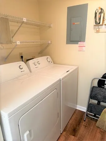 a kitchen with granite countertop white cabinets and white appliances