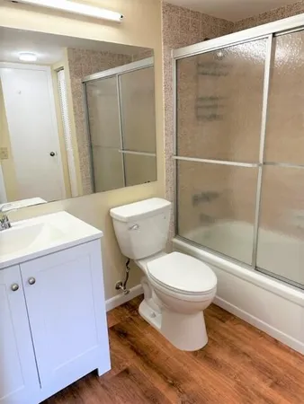 a bathroom with a toilet and a shower