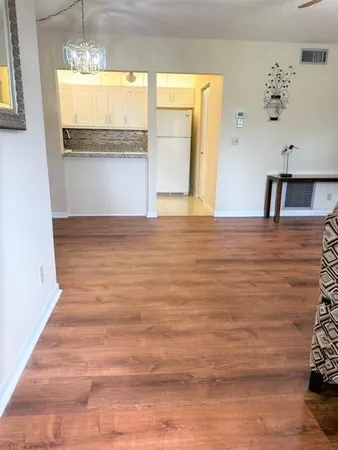 a view of a room with wooden floor and window