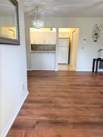 a living room with a couch and wooden floor