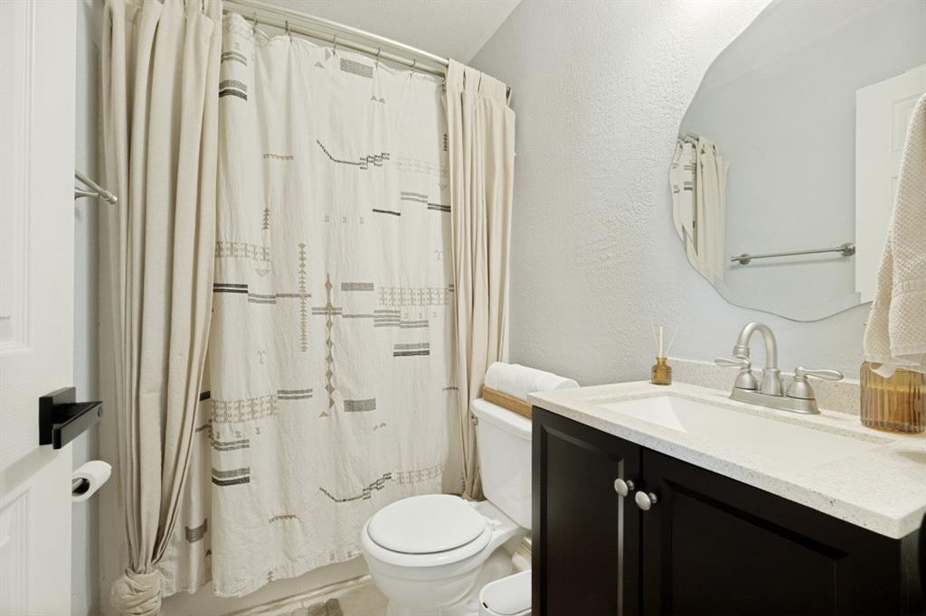 11709 Harbor Road Frisco, TX 75035 - Photo 9 of 12 a bathroom with a granite countertop sink toilet and shower
