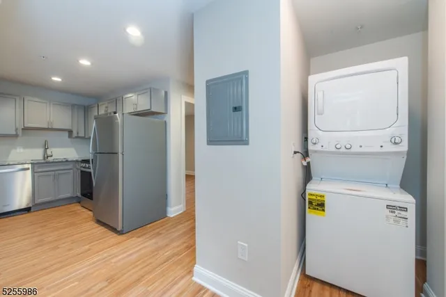 a kitchen with a refrigerator and cabinets