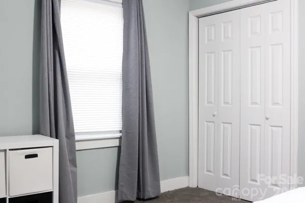a view of hallway with furniture and a potted plant