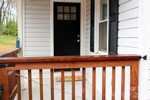 a balcony with wooden floor and fence