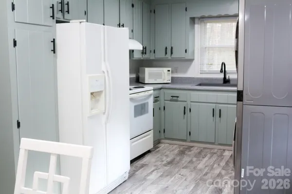 a white refrigerator freezer sitting inside of a kitchen