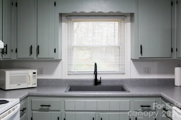 a kitchen with a sink and a window