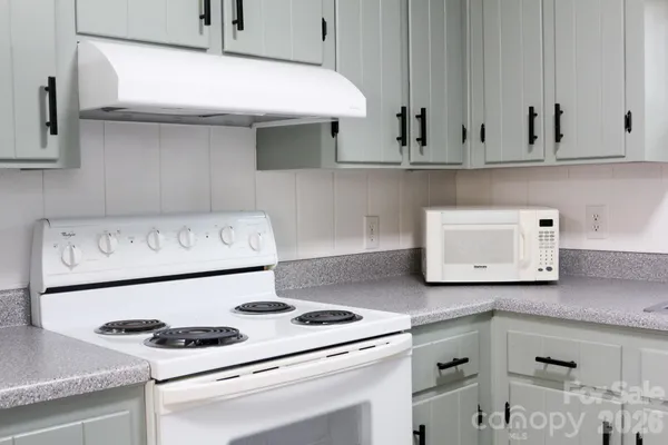 a stove top oven sitting inside of a kitchen
