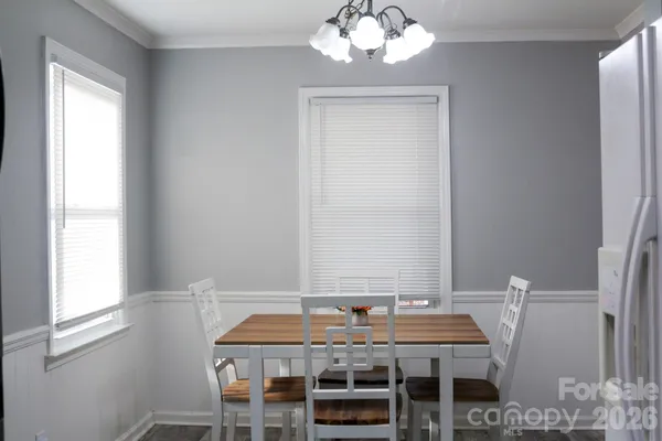 a view of a dining room with furniture and chandelier