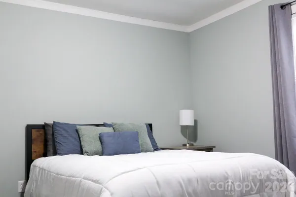 a bedroom with a bed and lamp