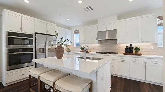 a kitchen with a sink stove and refrigerator