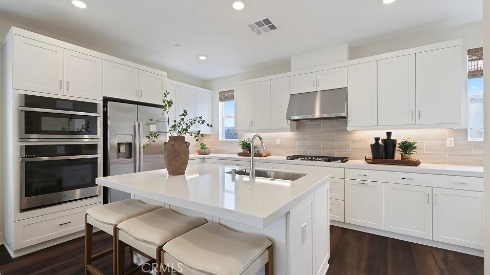 a kitchen with a sink stove and refrigerator