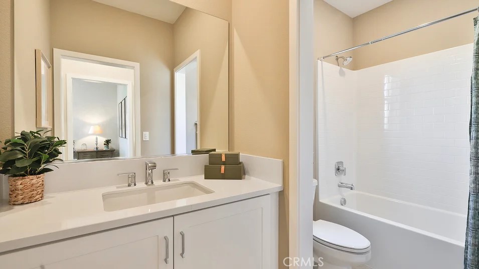 27463 Sand Almond Way Newhall, CA 91381 - Photo 14 of 26 a bathroom with a sink a toilet a tub and shower