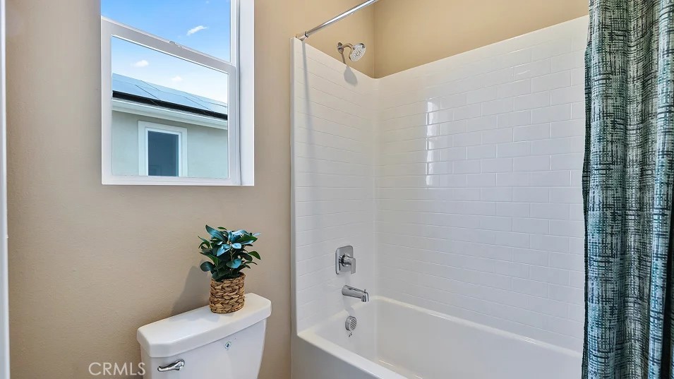 27463 Sand Almond Way Newhall, CA 91381 - Photo 17 of 26 a white bath tub sitting next to a toilet