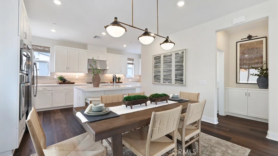 27463 Sand Almond Way Newhall, CA 91381 - Photo 4 of 26 a kitchen and a dining table chairs in it