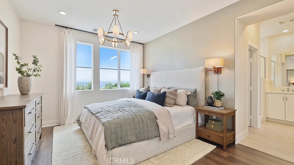 27463 Sand Almond Way Newhall, CA 91381 - Photo 8 of 26 a bedroom with a bed a chandelier and dresser