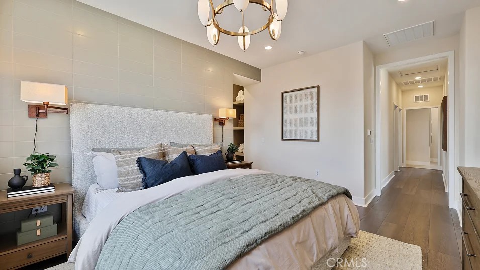 27463 Sand Almond Way Newhall, CA 91381 - Photo 9 of 26 a bedroom with a bed and a chandelier