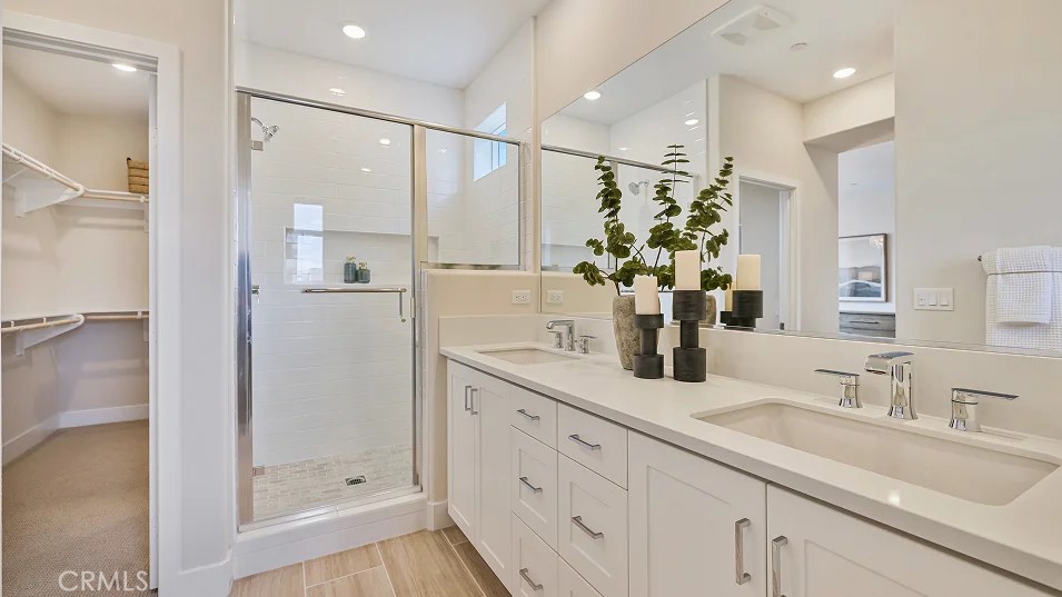 27463 Sand Almond Way Newhall, CA 91381 - Photo 10 of 26 a bathroom with a double vanity sink mirror and shower