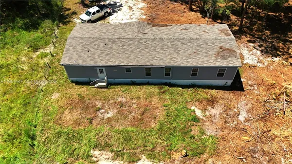 a view of house with yard and outdoor seating