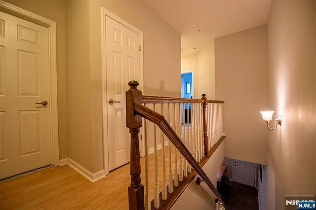 a view of a hallway with wooden floor and entryway