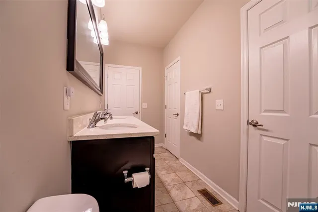 a bathroom with a sink mirror and toilet