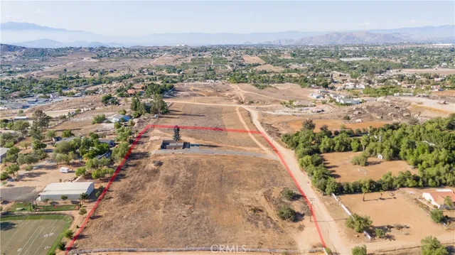 an aerial view of residential house and sandy dunes