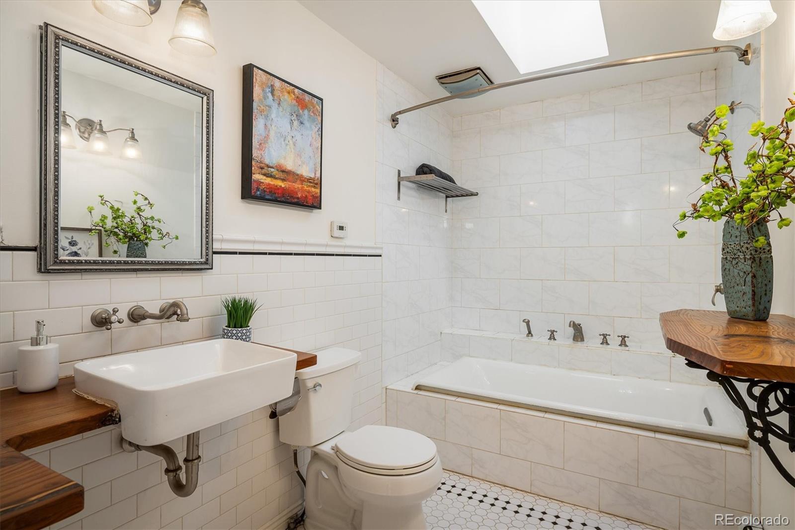 855 Main Street Boulder, CO 80302 - Photo 14 of 41 a bathroom with a sink a toilet and a mirror